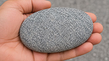Smooth weak stone in hand